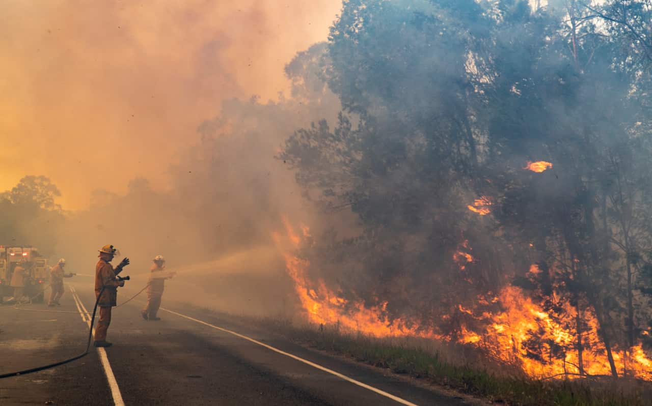 Queensland is bracing for hot and dry winds as NSW fires are set to cross the northern border on Wednesday.
