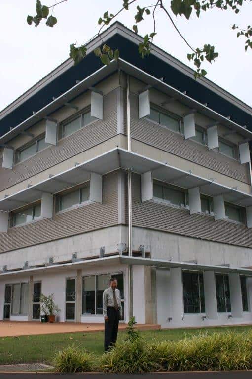 Laurence Ah Toy standing in front of home economics building named after him at Darwin High School. 