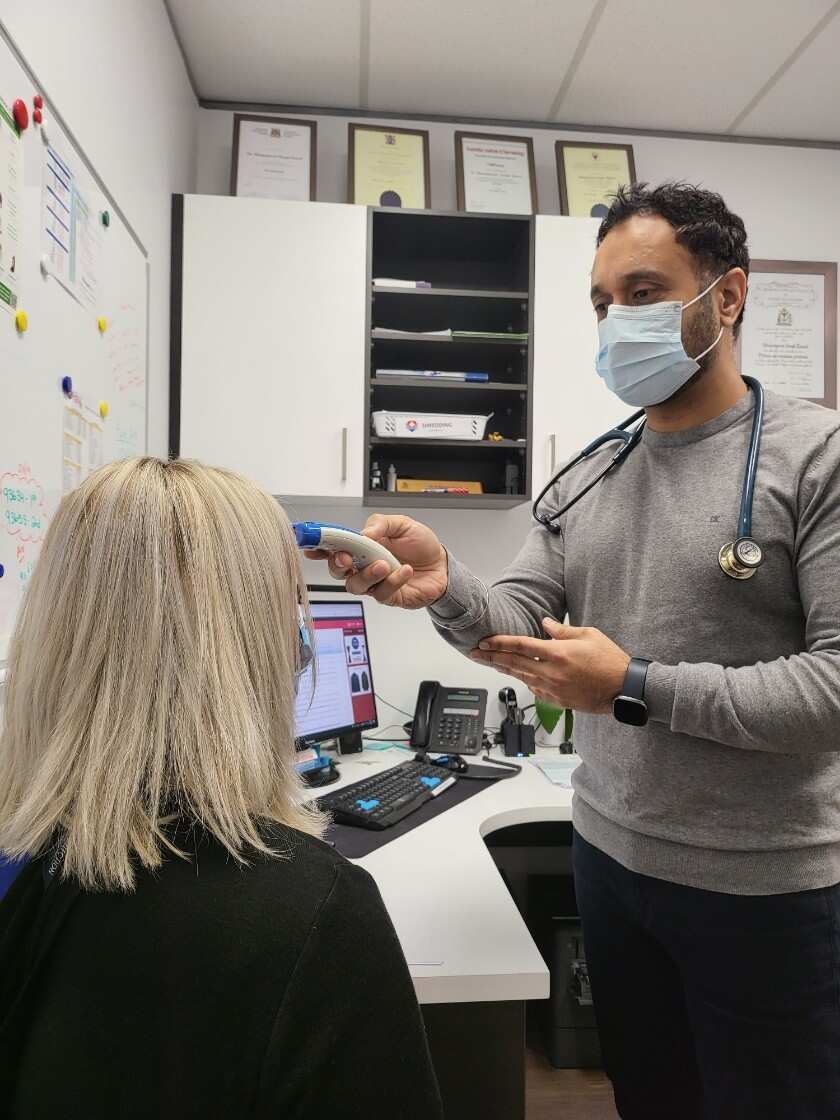 Dr Bhajanpreet Singh Rawal while examining a patient at his clinic.