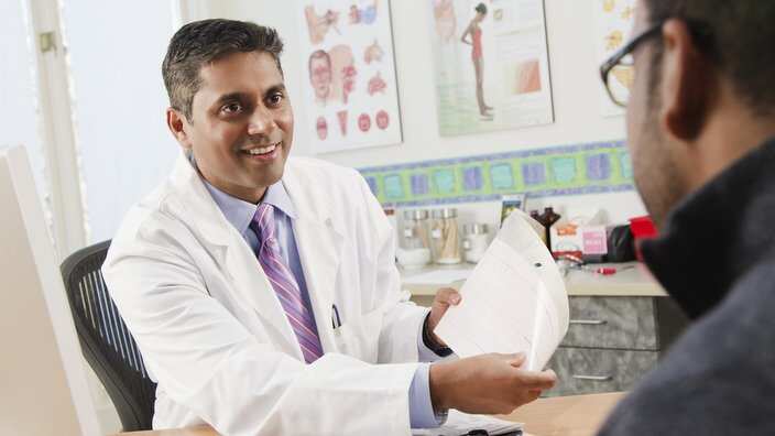 Doctor talking to patient in doctor's office