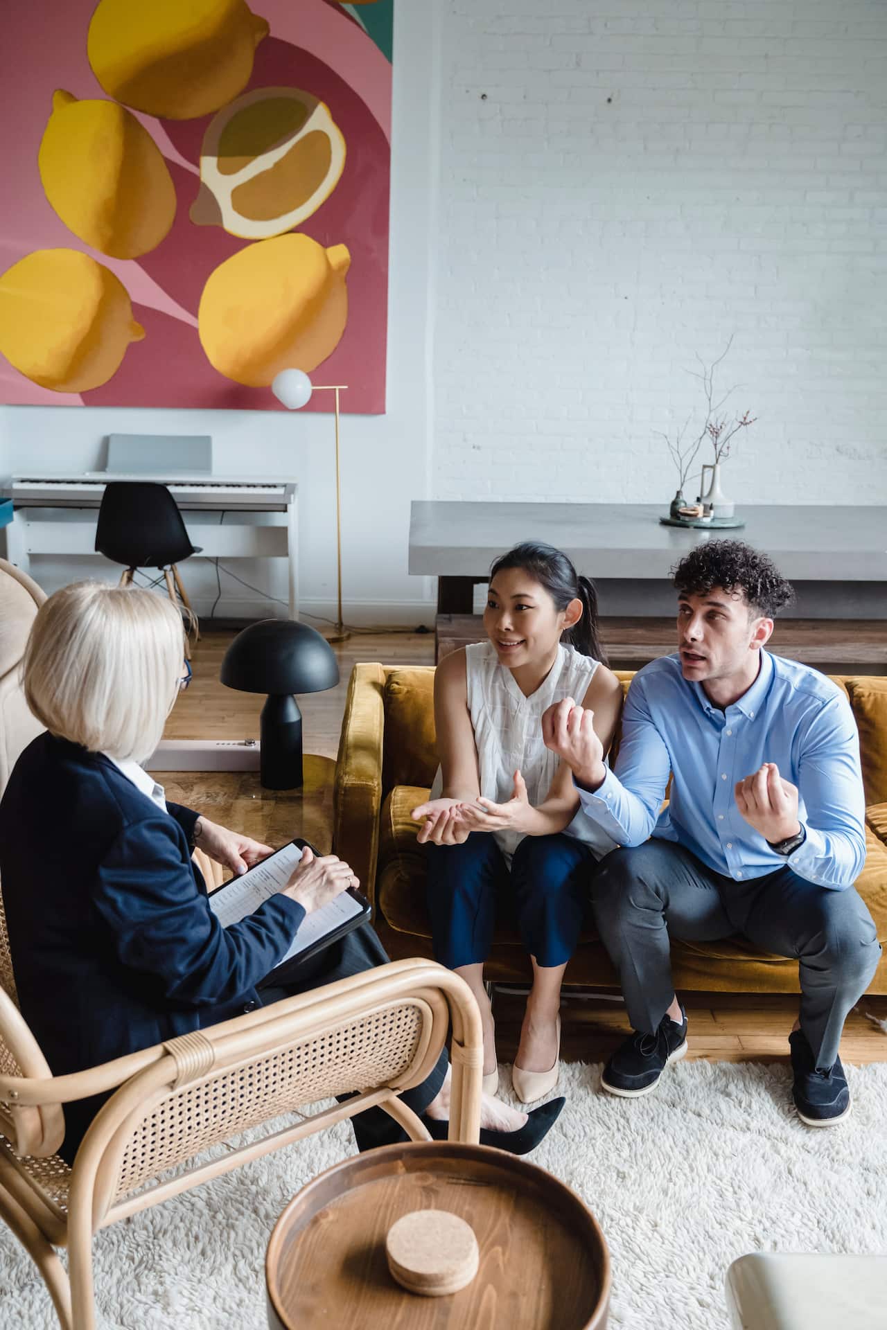 A couple sitting on the couch talking to the counsellor