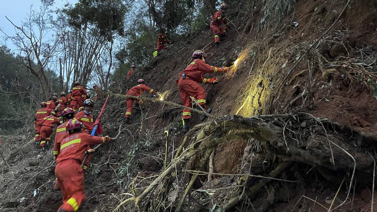 Rescuers conduct search operations at the site of a plane crash in Tengxian County in southern China's Guangxi Zhuang Autonomous Region on Tuesday, 22 March, 2022.