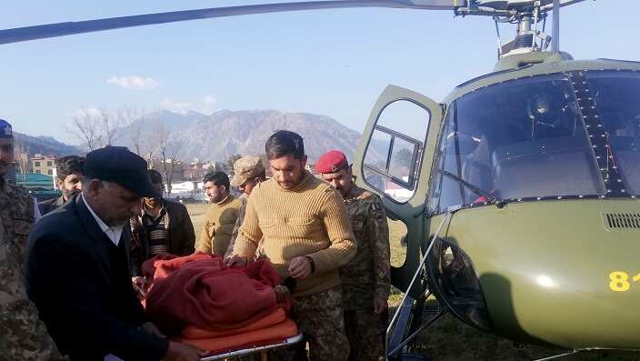 Pakistan army soldiers transport an injured victim of an avalanche, at a helipad in Muzaffarabad, the capital of Pakistan-administered Kashmir, Tuesday, Jan. 14, 2020. AP Photo/M.D. Mughal
