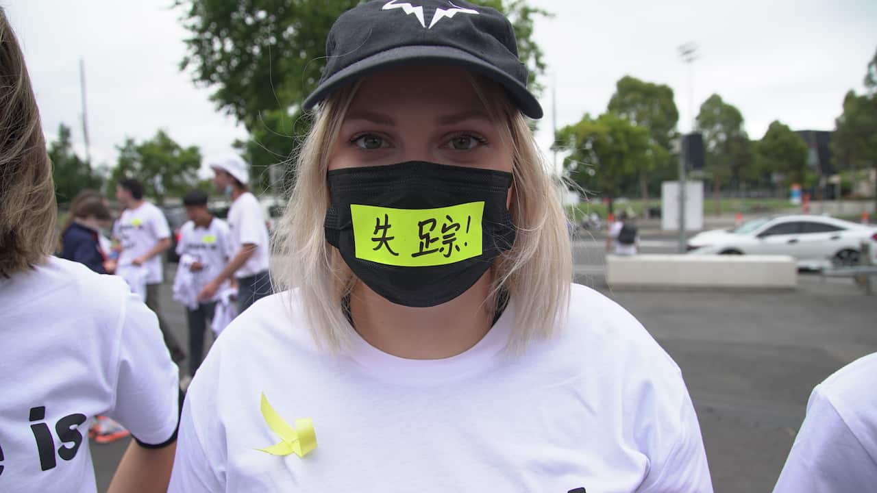 Tennis spectator Libby Brown wearing sticker saying 'missing' in Chinese. 