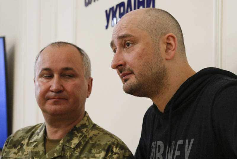 Russian journalist Arkady Babchenko, right, and Vasily Gritsak, head of the Ukrainian Security Service speaks to the media during a news conference at the Ukrainian Security Service on Wednesday, May 30, 2018.