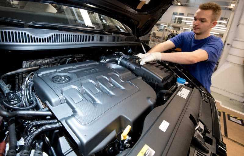 A technician works on a Volkswagen Tiguan with TDI diesel engine during its final assembly at the Wolfsburg Volkswagen plant. 