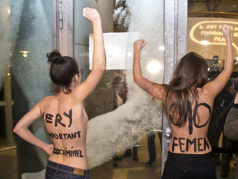 Femen activists protest outside a film retrospective to Roman Polanski