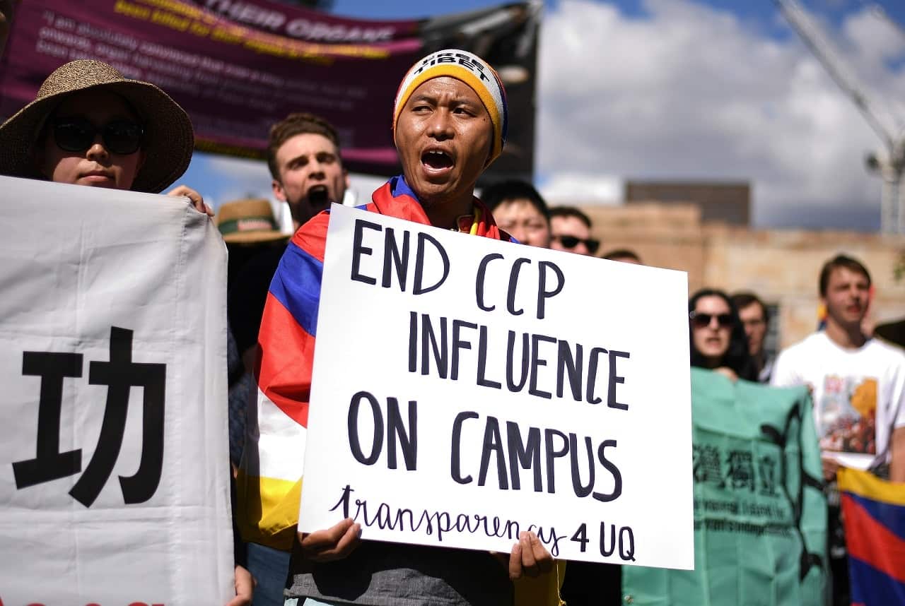 Protesters hold placards at the rally.