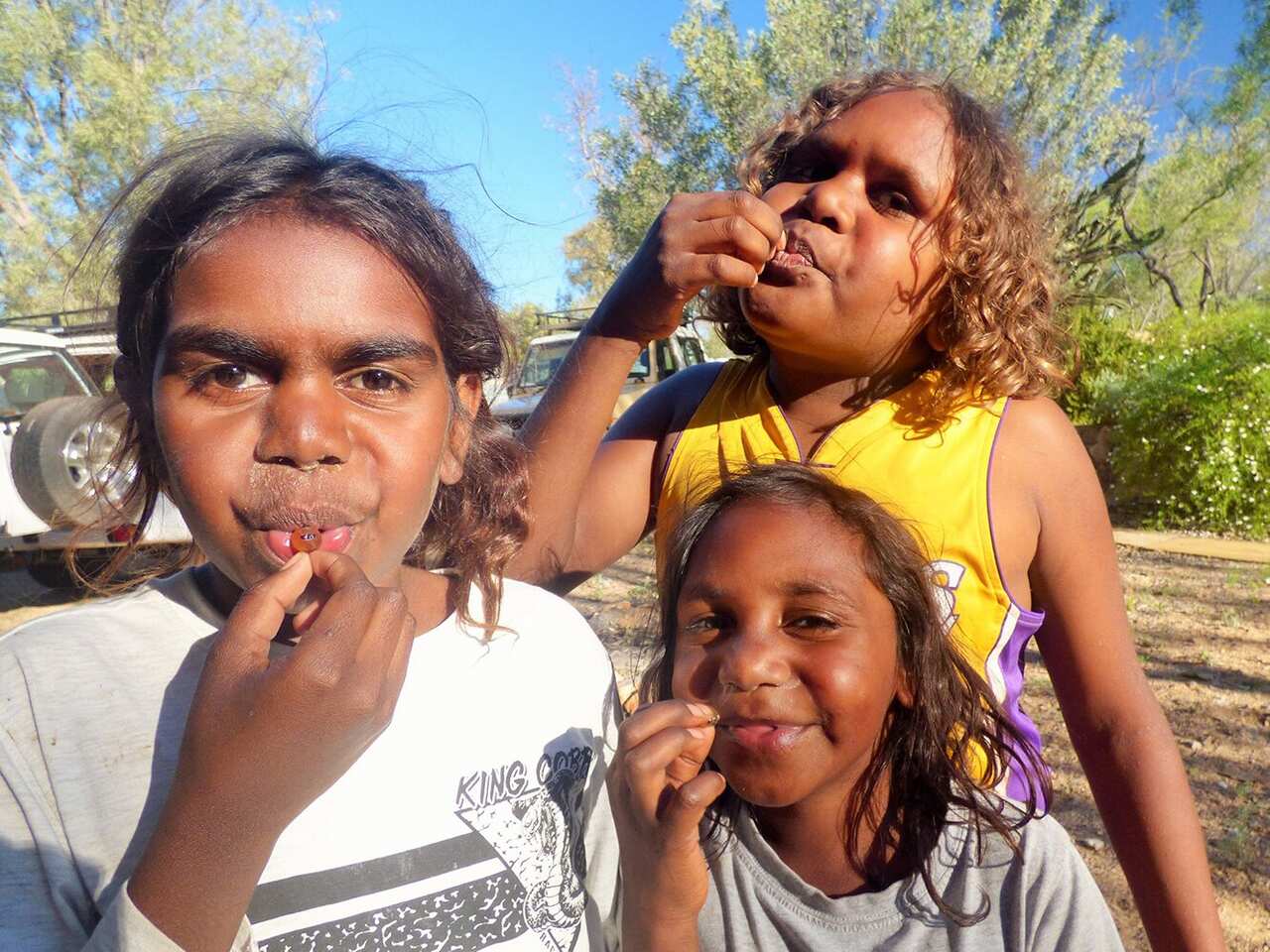 Indigenous childrean eat native foods such as honey ants near Alice Springs as a part of the Children's Ground early education program.