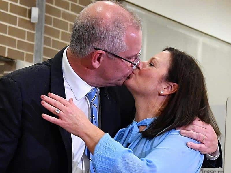 Scott Morrison kisses wife Jenny after casting his vote.