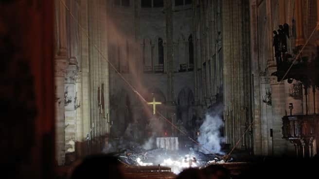 Photos Inside Notre Dame Show Charred Alter With A Hanging Cross Intact