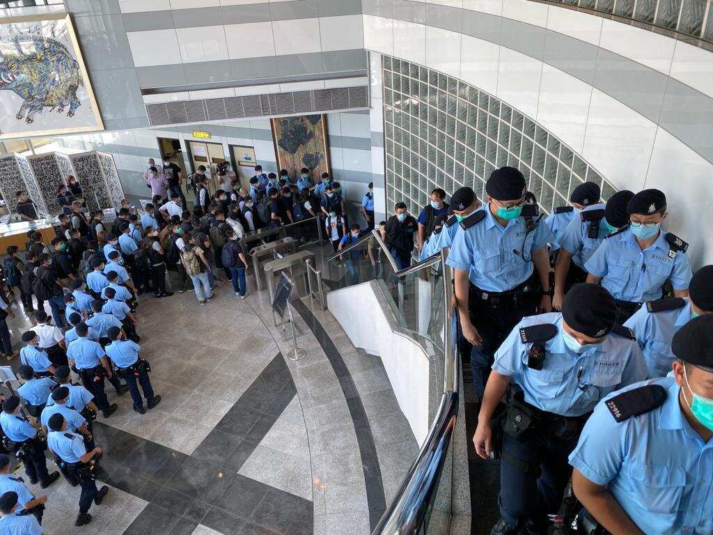 Scores of Hong Kong police raid the Apple Daily newspaper in Hong Kong.