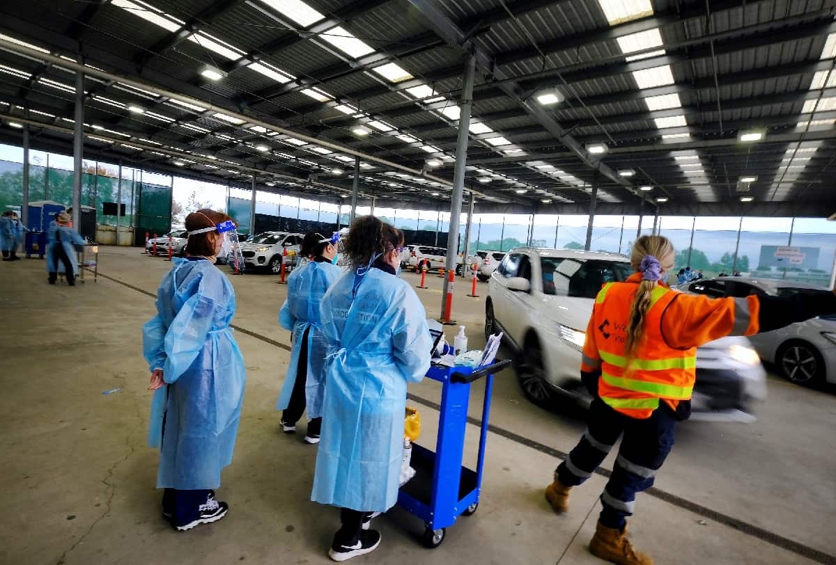 Health workers at a drive-through COVID-19 vaccine hub in Melton in Melbourne on 9 August 2021. 