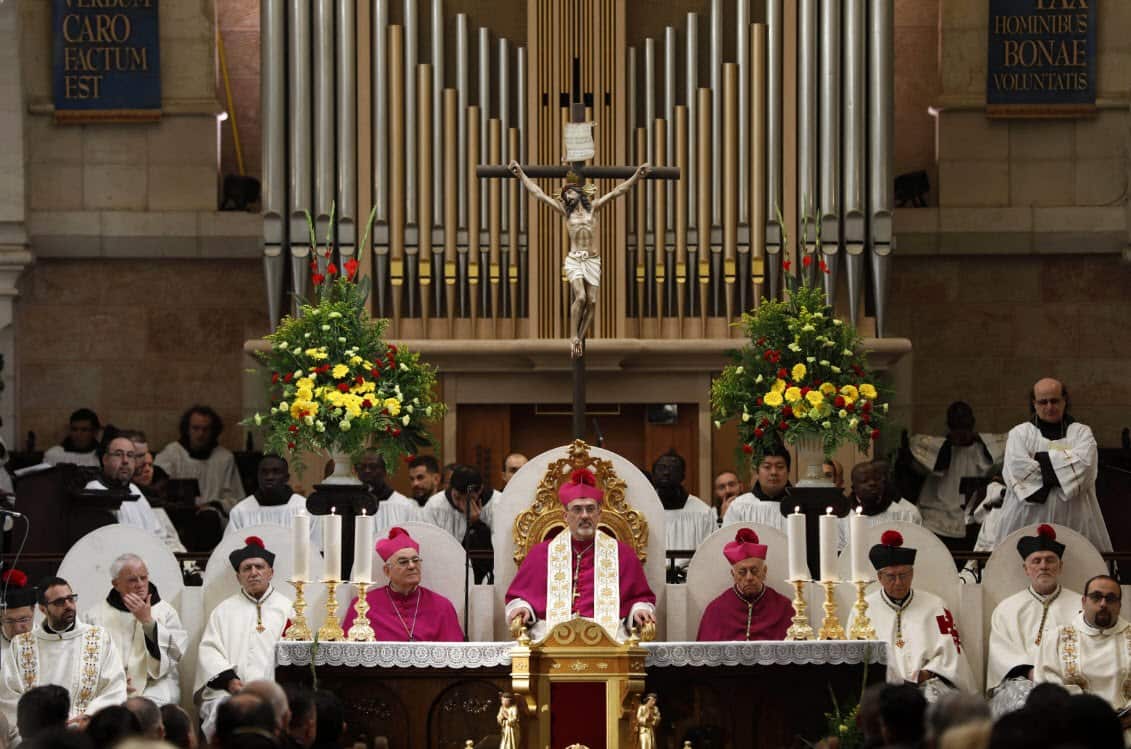  The Apostolic Administrator of Jerusalem, Pierbattista Pizzaballa (C) attends a mass on Christmas Eve inside the Church of the Nativity, in the West bank town of Bethlehem, 24 December 2018 (AAP)