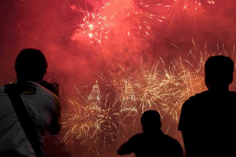 Spectators watch as fireworks explode in front of Malaysia's landmark building, the Petronas Twin Towers, during the New Year's celebration in Kuala Lumpur.