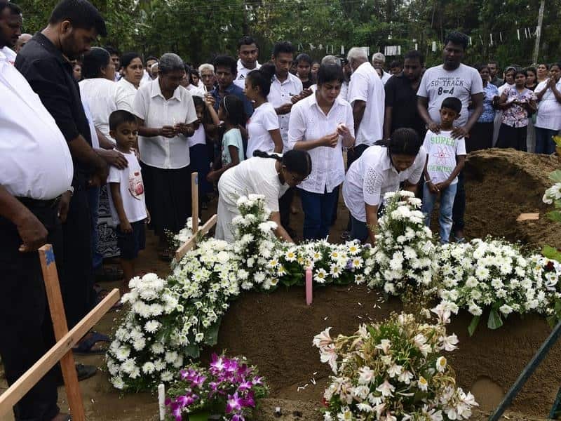 The family of a victim mourns at a graveside