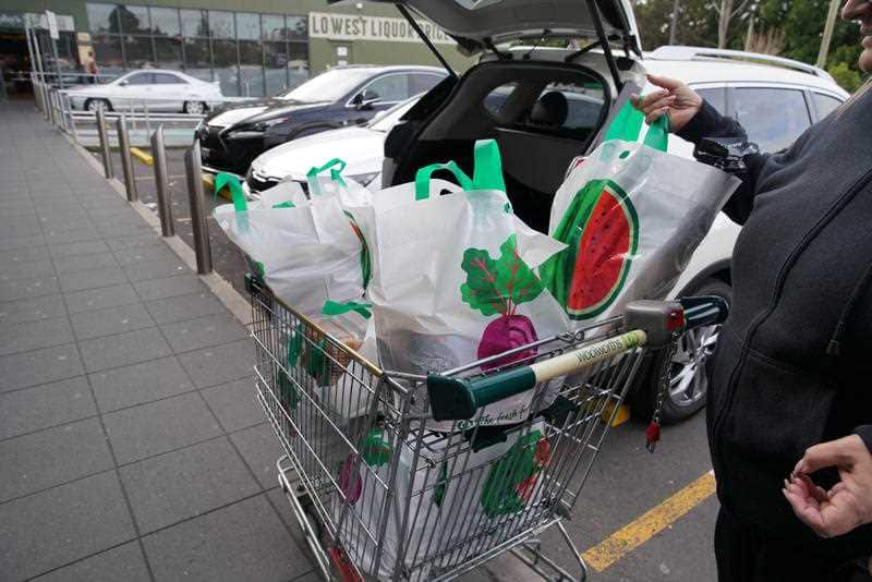 A lady unloads her re-useable plastic bags provided by Woolworths at Wolli Creek, Sydney, Monday, July 2, 2018.