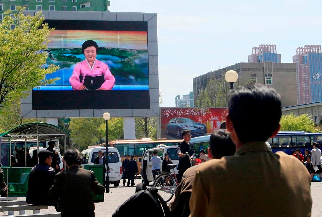 North Koreans watch as their country's most famous newscaster announces leader Kim Jong-un's proposal to suspend nuclear tests.