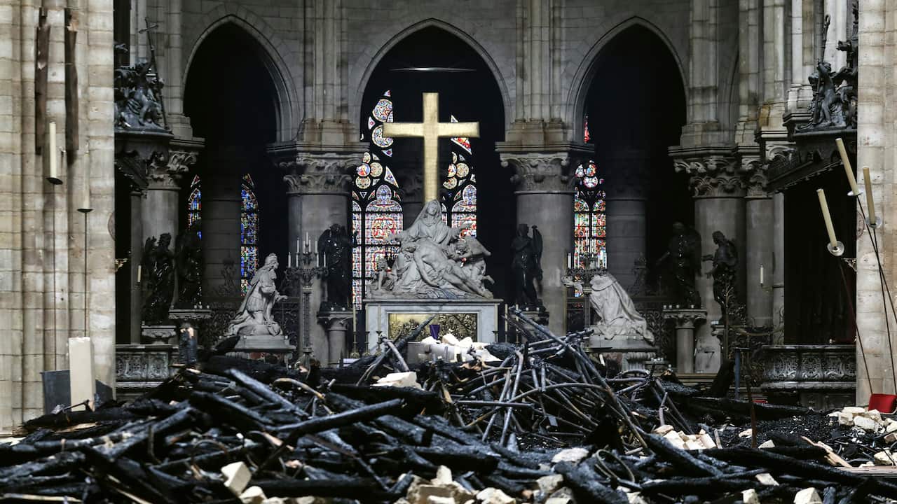 A picture taken on April 16, 2019 shows the altar surrounded by charred debris inside the Notre-Dame Cathedral in Paris.