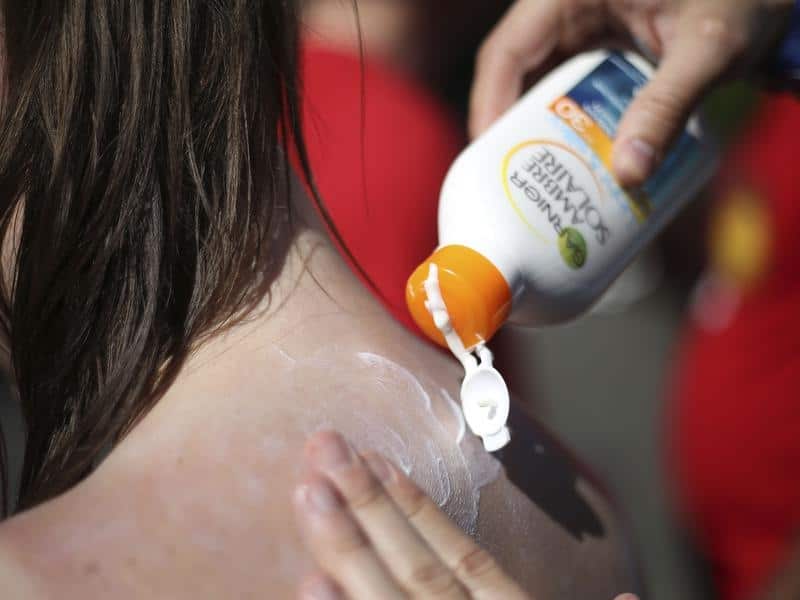 People apply sunscreen