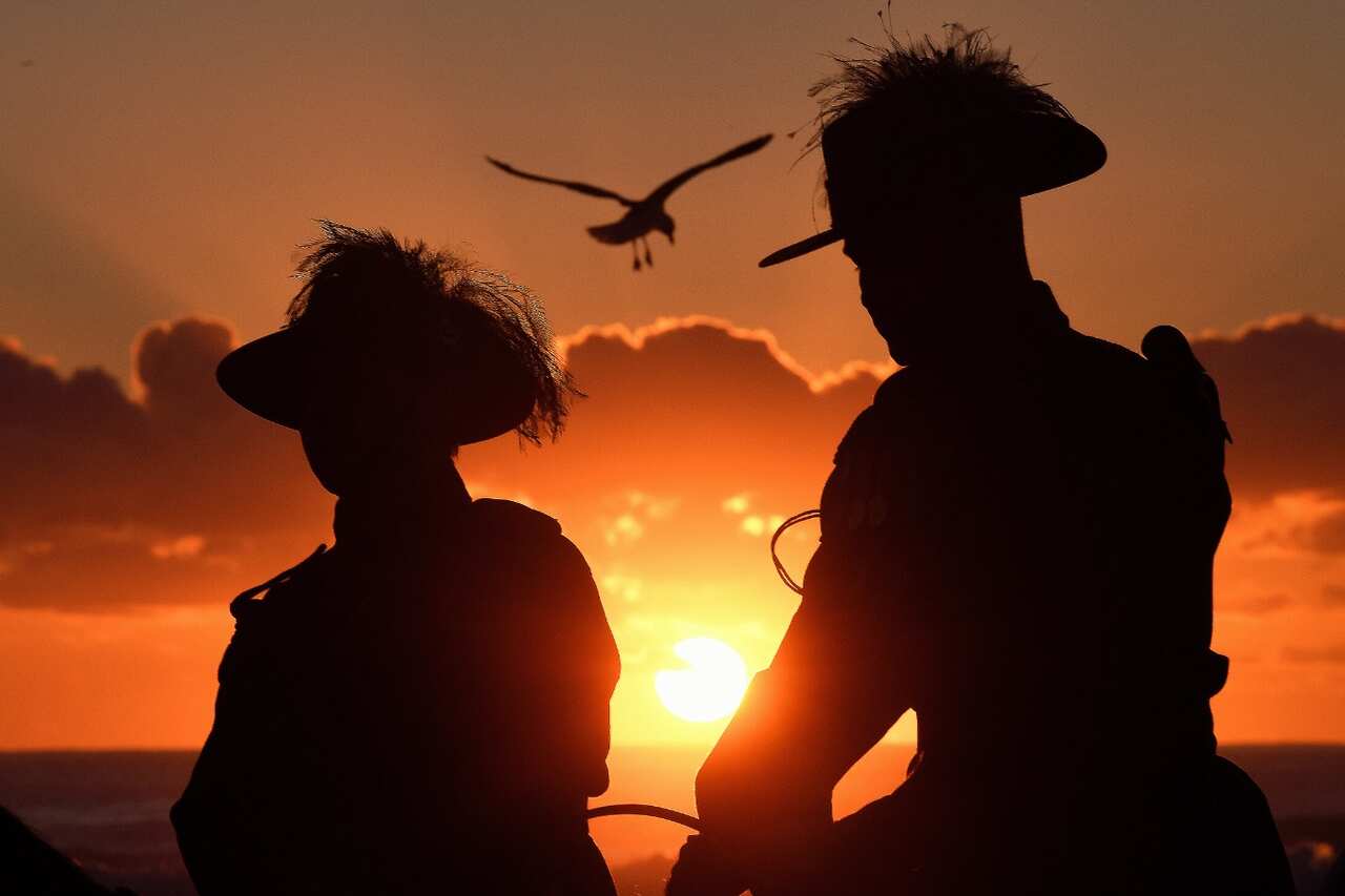 The Anzac Day dawn service held by the Currumbin RSL is seen at Elephant Rock on Currumbin Beach, Gold Coast (AAP)