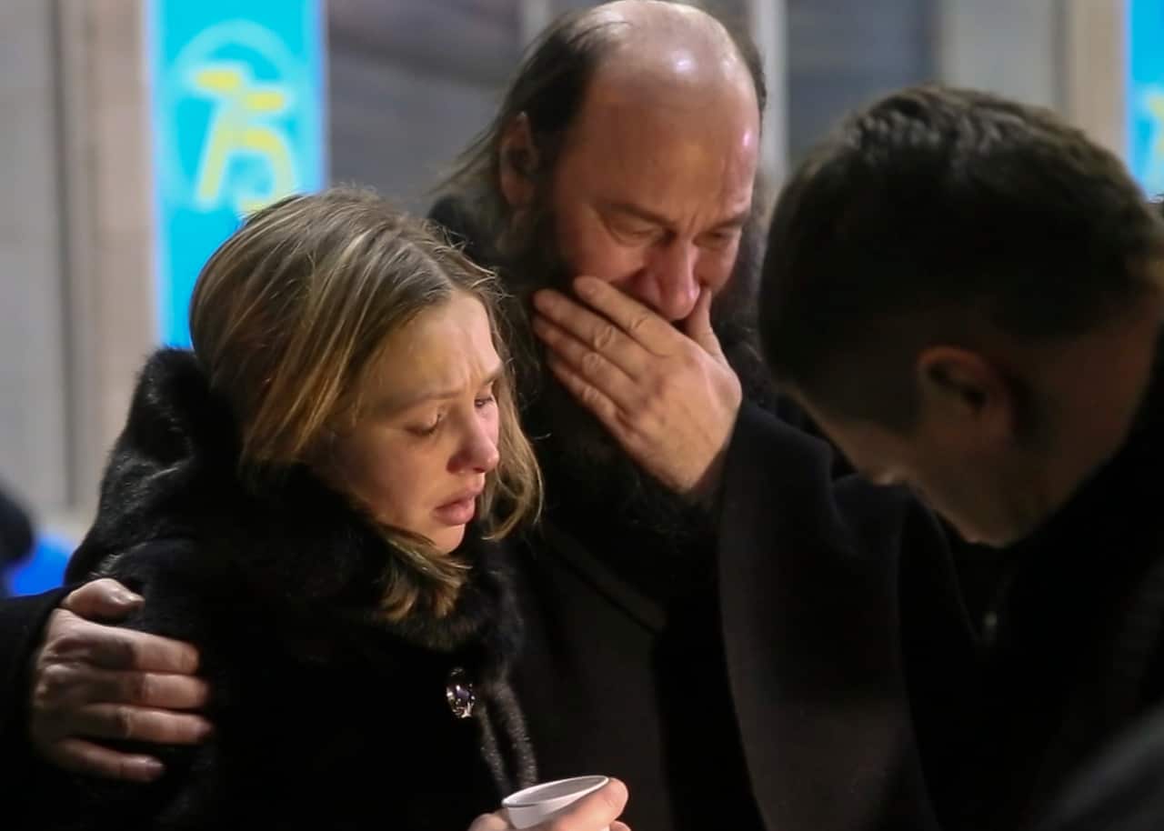 Relatives and friends of those on the Saratov Airlines airline plane An-148 flight that crashed near Moscow's airport Domodedovo comfort each other 