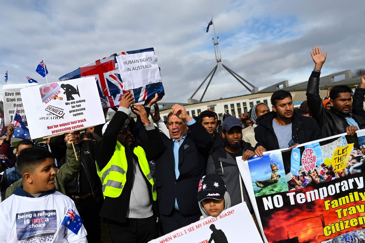 Temporary Protection Visa (TPV) and Safe Haven Enterprise Visa (SHEV) holders are seen as they attend a rally outside Parliament House in Canberra, Monday, 29 July, 2019. (AAP Image/Lukas Coch) NO ARCHIVING