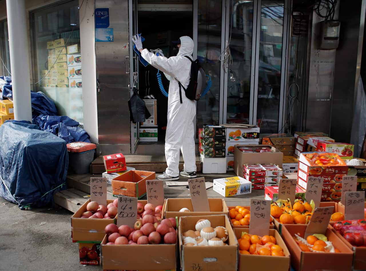 A worker wearing a protective suit in Seoul.