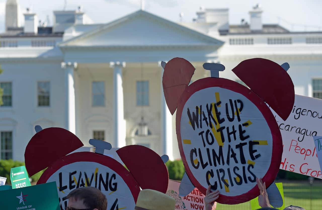 Protesters gather outside the White House to protest President Donald Trump's decision to withdraw the US from the Paris climate change accord.