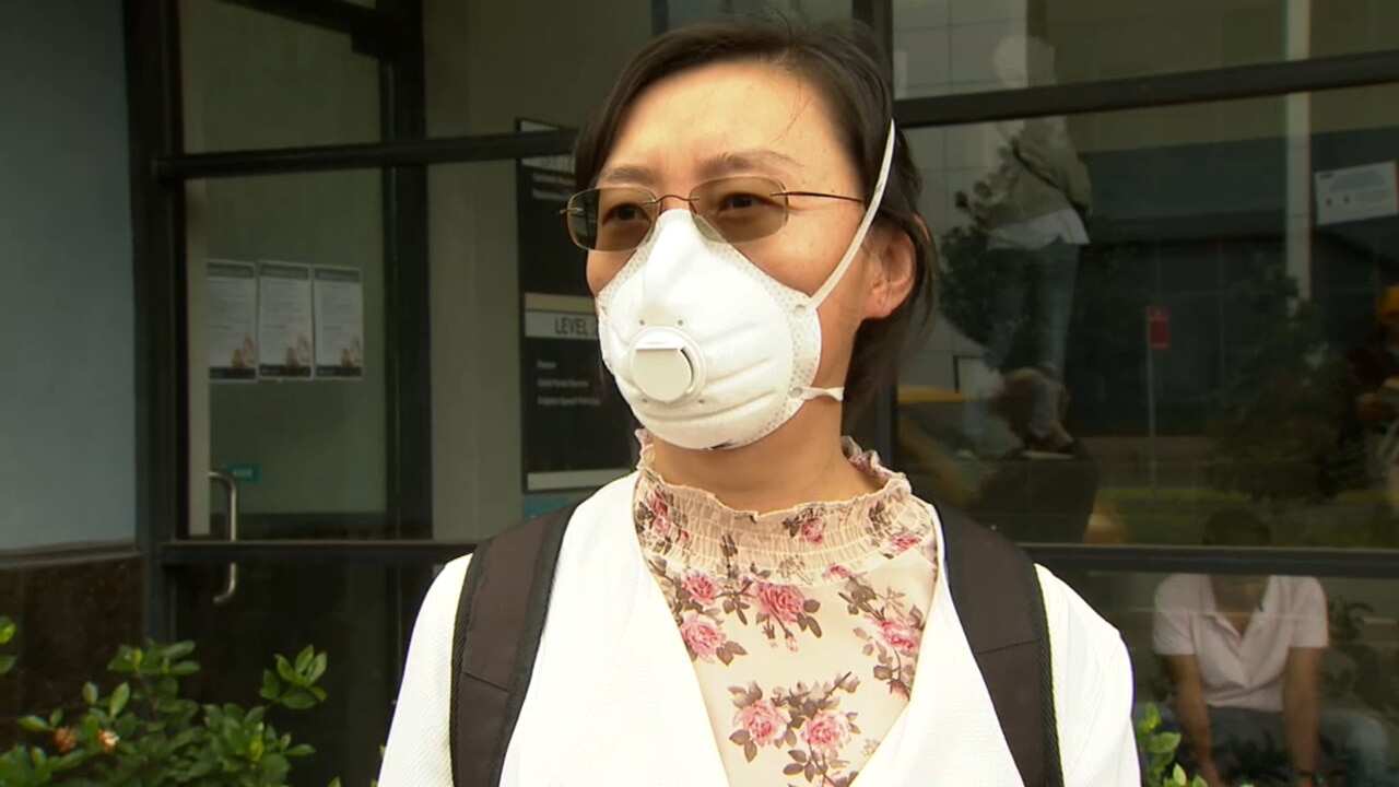 A woman waits in the Centrelink queue.