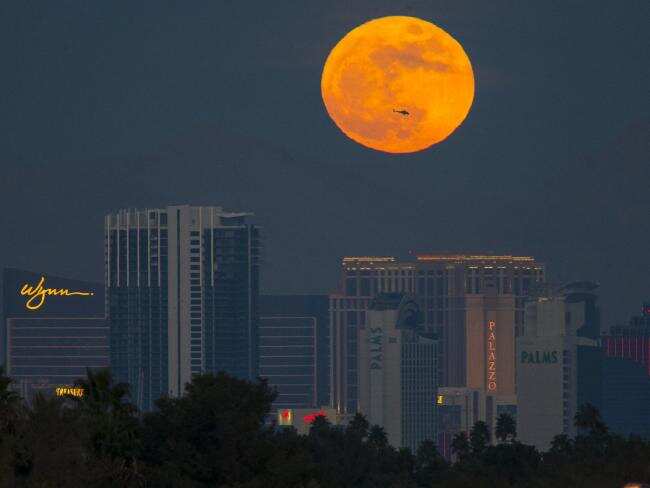 The first supermoon of the new year rises above the Vegas Strip on January 1.