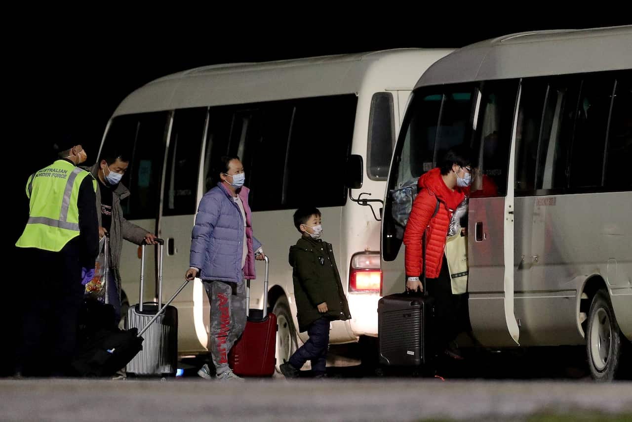 Evacuees arriving at the airport on Christmas Island.Credit...