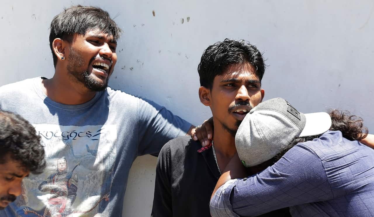 Relatives of people killed in Church blasts mourn as they wait outside mortuary of a hospital in Colombo, Sri Lanka, Sunday, April 21, 2019. 