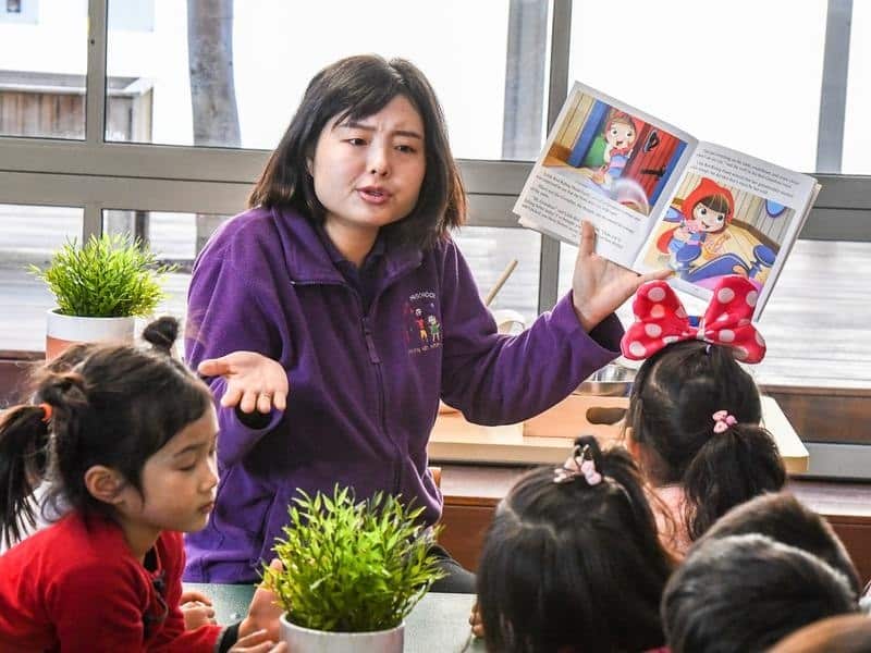 Preschool teacher Miss Jenny speaks to students