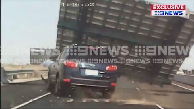 Freeway sign falls on car, injuring woman