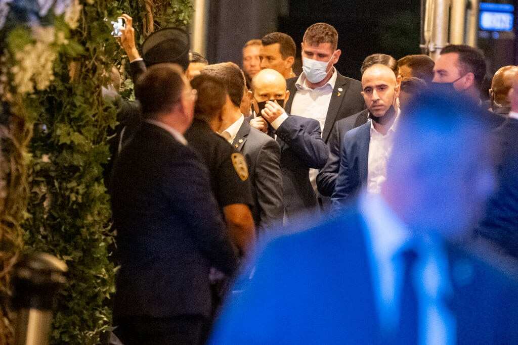 Israeli Prime Minister Naftali Bennett (C) walks back to his hotel in New York City on 27 September, 2021.