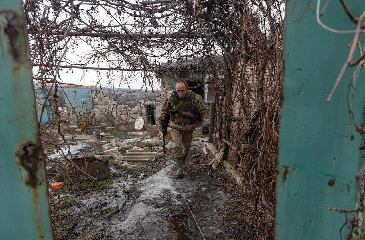 A Ukrainian soldier walks through an abandoned house at a line of separation from pro-Russian rebels, Donetsk region, Ukraine, Sunday, 9 January, 2022.