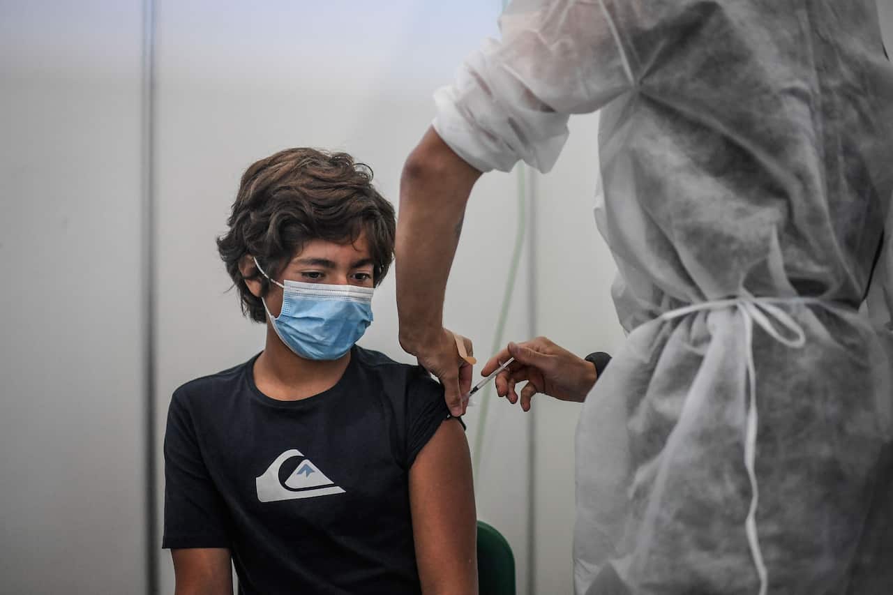 Diogo, 13 years old, is vaccinated against COVID-19 by a soldier at a vaccination center in Lisbon, on September 11, 2021.
