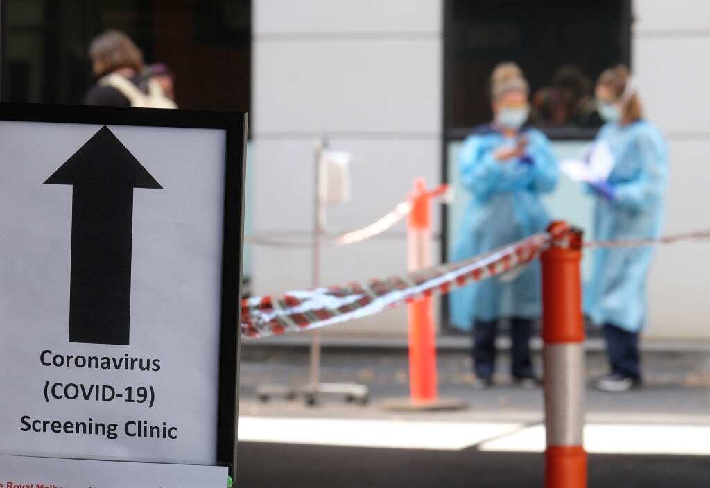 A sign directing people to the COVID-19 screening area is posted outside the Royal Melbourne Hospital in Melbourne, Australia.