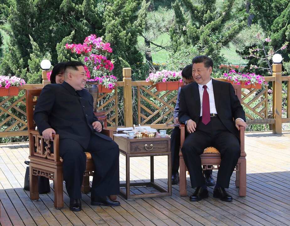 Chinese President Xi Jinping, right, speaks to North Korean leader Kim Jong-un in Dalian.