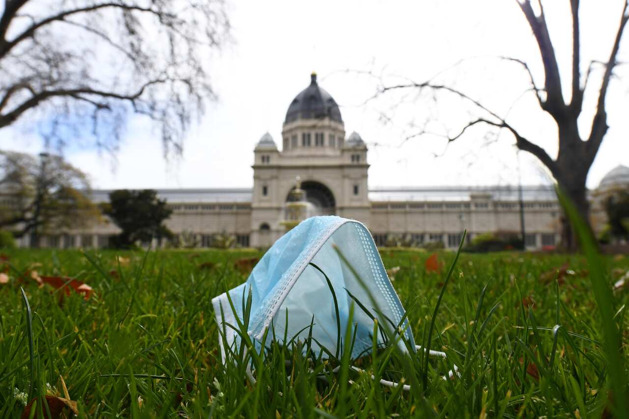 General view of a discarded single use mask face in Carlton Gardens, Melbourne, Wednesday, August 19, 2020. Victoria has recorded 216 new cases of coronavirus and 12 deaths in the past 24 hours (AAP Image/James Ross) NO ARCHIVING