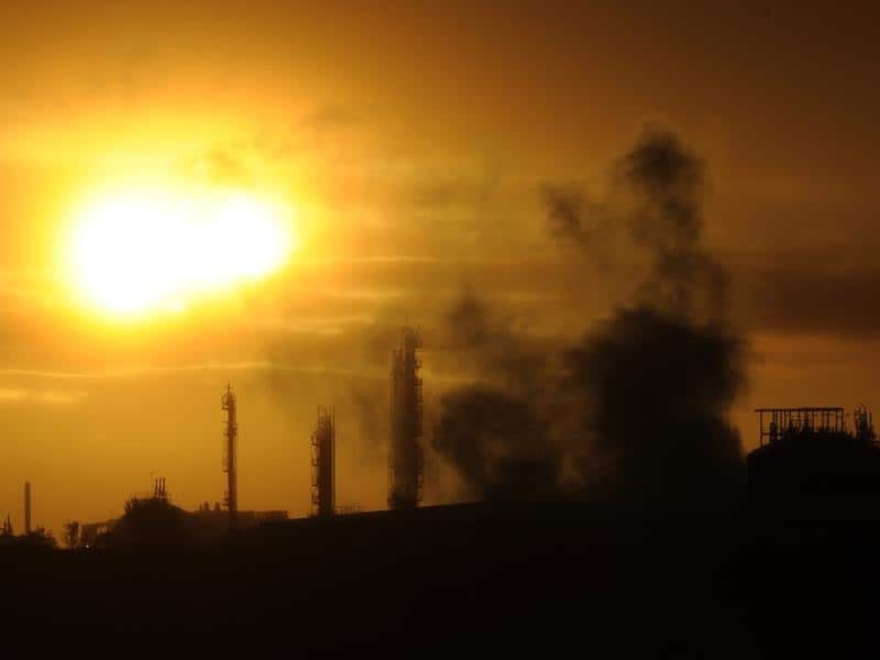 Steam and other emissions rise from an industrial plant