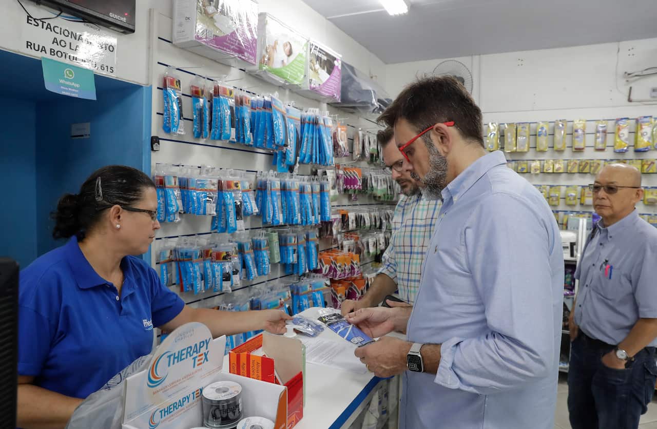 Customers buy masks at a medical supply store in Sao Paulo after Brazil's government confirmed the country's first confirmed case of the new coronavirus.