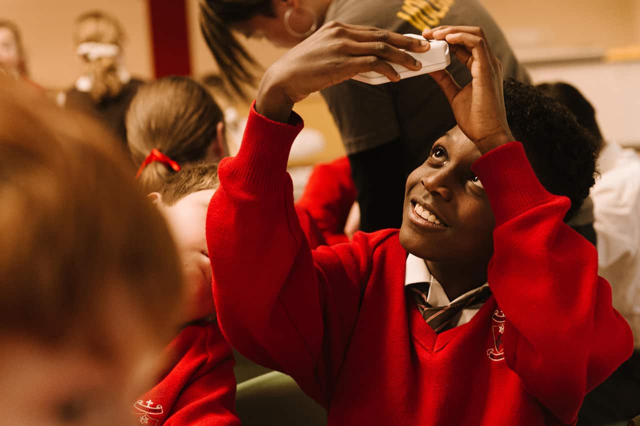 Children building portable solar powered lights 