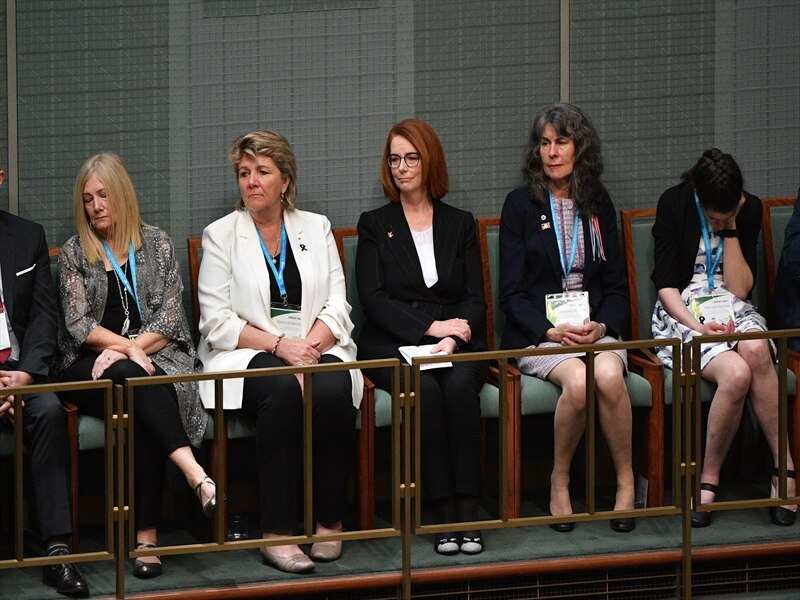 Julia Gillard listens to the apology for victims of child sex abuse