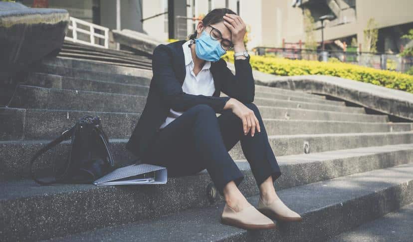 Unemployed businesswoman having stressed after failure and laid off from work because impact from covid-19 pandemic outbreak and economic depression.
