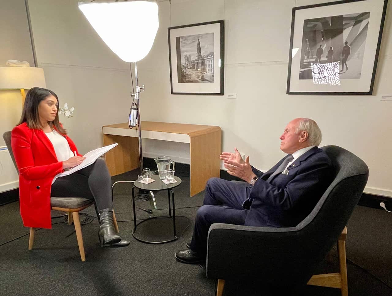 Former Prime Minister John Howard talks to SBS World News reporter Shuba Krishnan