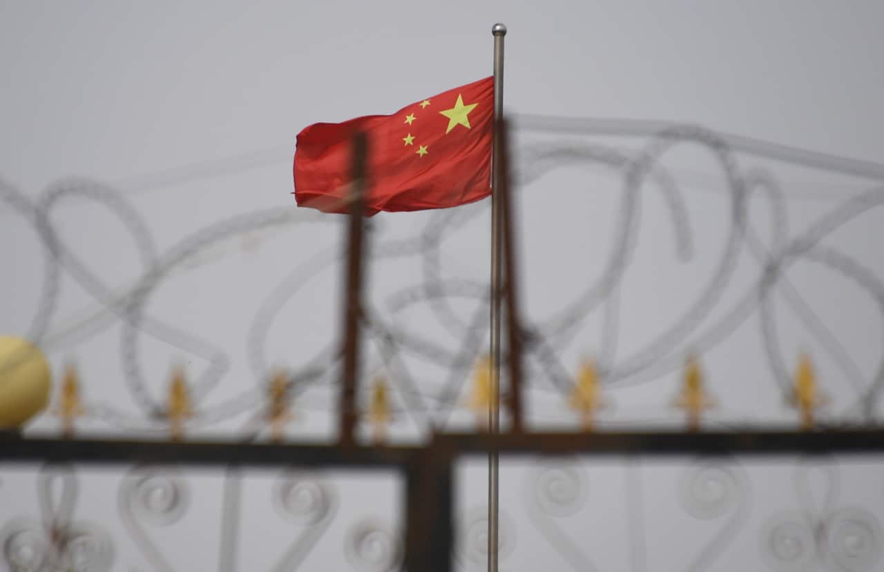 Chinese flag behind razor wire