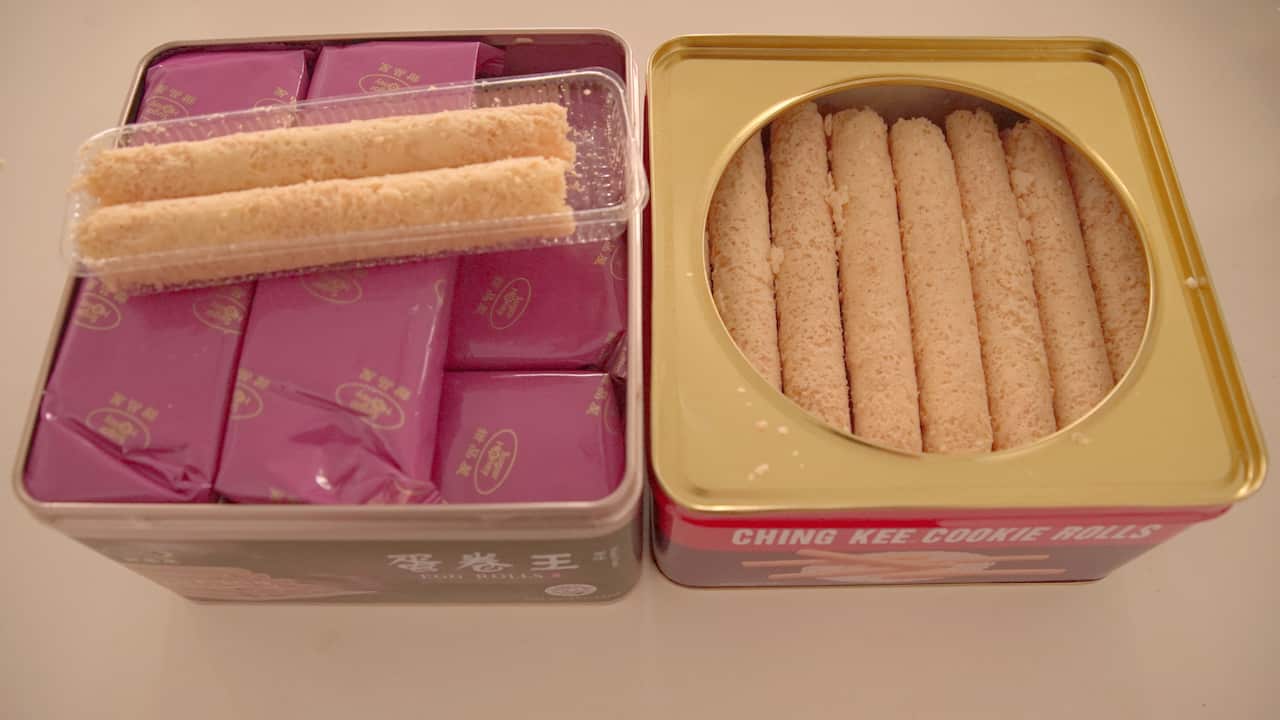 Egg rolls packed using multiple layers (left), loosely packed in another different tin.