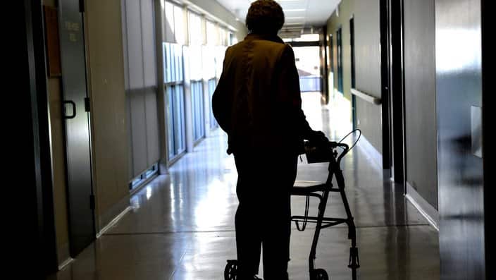 A woman uses a walker to assist her mobility in Canberra, Friday, May 24, 2013. (AAP Image/Alan Porritt) NO ARCHIVING